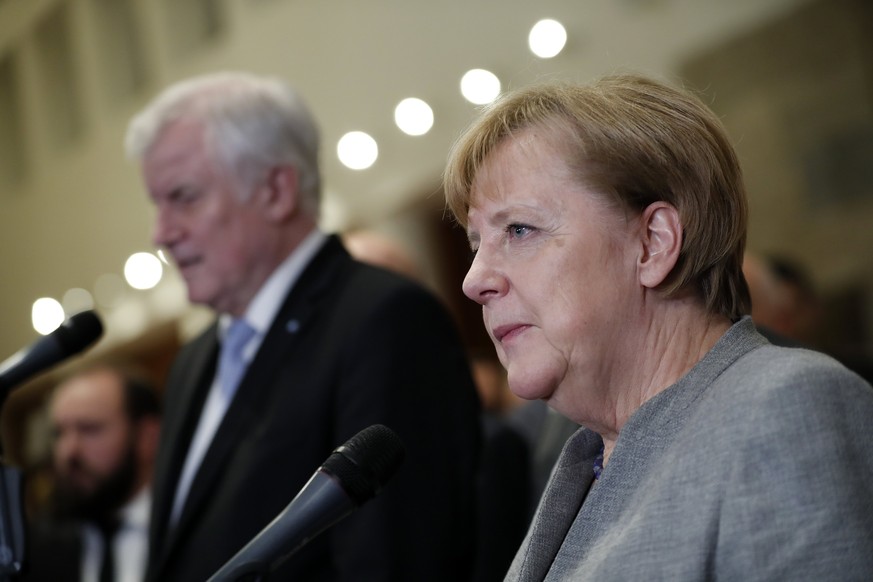 epa06339558 Chancellor Angela Merkel (R) and Bavarian state governor and chairman of the German Christian Social Union (CSU) party, Horst Seehofer (L) give a press statement in the Representative offi ...