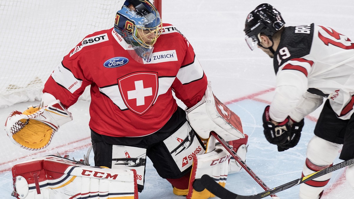 Switzerland’s goaltender Jonas Hiller, left, fights for the puck against Canada's Gilbert Brule during the 2017 Karjala Cup ice hockey match between Switzerland and Canada in the Tissot Arena in  ...