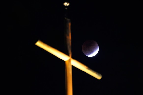A total lunar eclipse is seen behind a cross over a church in Seoul, South Korea, Tuesday, March 3, 2026. (AP Photo/Ahn Young-joon)
South Korea Blood Moon Eclipse