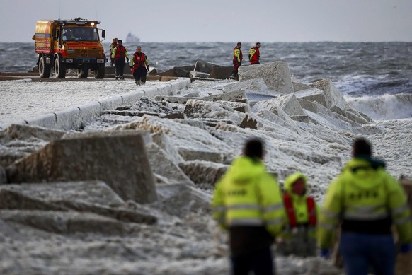 epa08415734 General view of rescue workers at the Noordelijk Havenhoofd (northern pier) in Scheveningen, Netherlands, 11 May 2020, where two surfers have died. A large-scale rescue mission was underwa ...