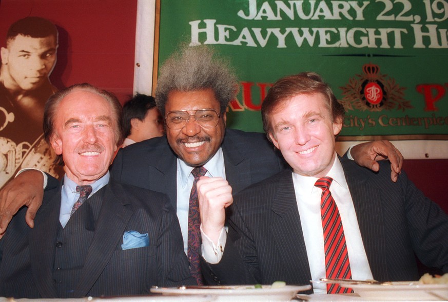 FILE - In this Dec. 1987 file photo, Donald Trump, right, pictured with his father, Fred Trump, left, and boxing promoter Don King participate in news conference in Atlantic City, N.J. Trump once clai ...