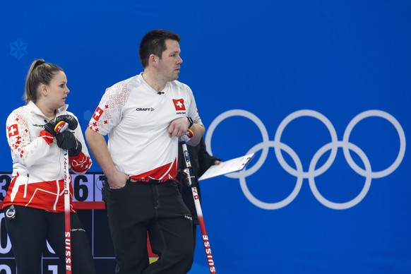 Jenny Perret, left, and Martin Rios of Switzerland team during the curling mixed doubles preliminary round game between Czech Republic and Switzerland at the 2022 Olympic Winter Games in Beijing, Chin ...