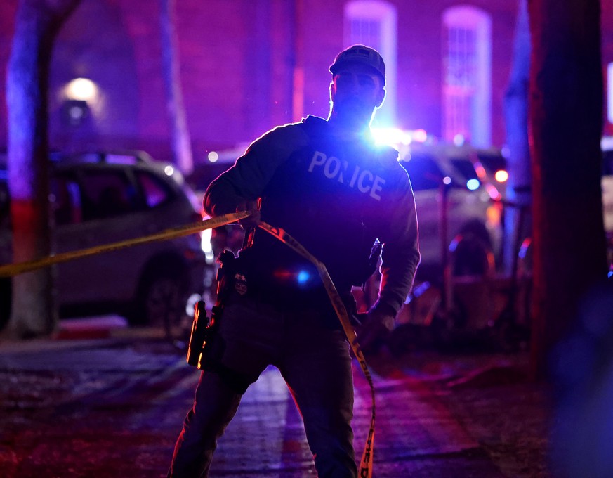 A police officer hangs yellow crime tape at Brown University in Providence, R.I., on Saturday, Dec. 13, 2025, during the investigation of a shooting. (AP Photo/Mark Stockwell)
APTOPIX Brown University ...