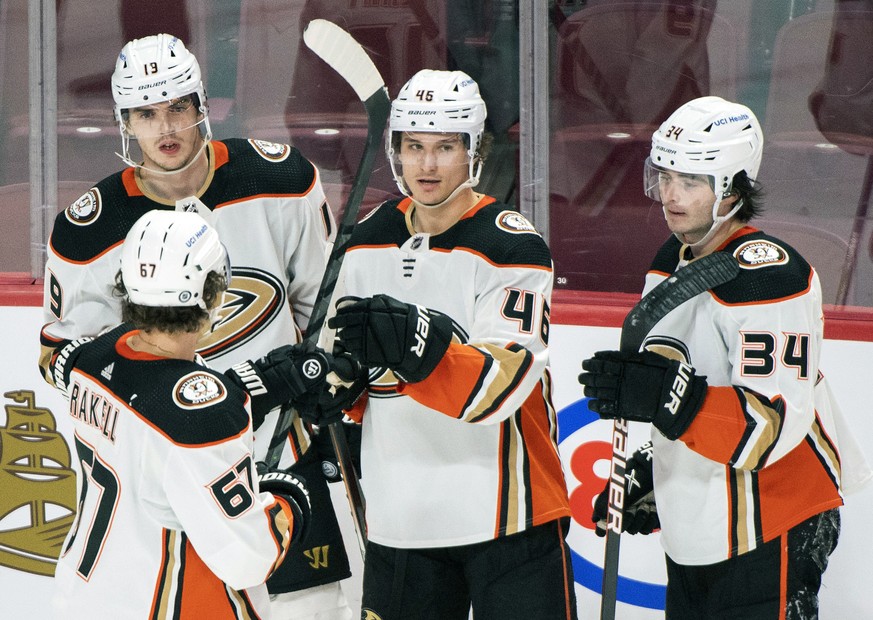Anaheim Ducks&#039; Trevor Zegras (46) celebrates with teammates Rickard Rakell (67), Troy Terry (19) and Jamie Drysdale (34) after scoring against the Montreal Canadiens during the second period of a ...