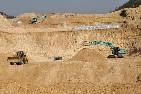 FILE - Workers use machinery to dig at a rare earth mine in Ganxian county in central China&#039;s Jiangxi province on Dec. 30, 2010. (Chinatopix via AP, File)
China Rare Earths Policy-What to Know