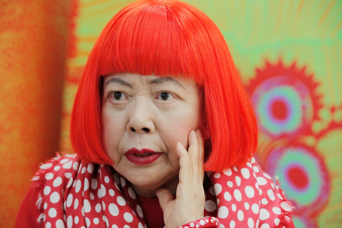 FILE - Japanese avant-garde artist Yayoi Kusama, wearing a bright red wig and a Louis Vuitton polka dot scarf, speaks during an interview at her studio in Tokyo, on Aug. 1, 2012. (AP Photo/Itsuo Inouy ...