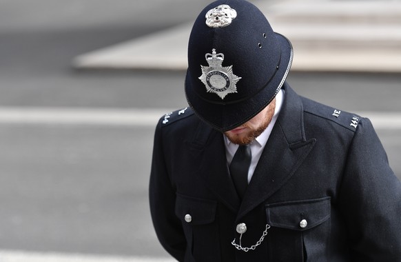 epa10193345 A police officer bows their head during the State Funeral of Queen Elizabeth II in London, Britain, 19 September 2022. Britain&#039;s Queen Elizabeth II died at her Scottish estate, Balmor ...