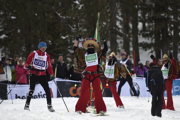 Participants tumble at the Stazerwald near St. Moritz, during the annual Engadin cross-country skiing marathon from Maloja to S-Chanf in south Eastern Switzerland, Sunday, March 13, 2016. Thousands of sportsmen and -women are on their way from Maloya to S-Chanf in south Eastern Switzerland as they participate in the annual Engadin skiing marathon. (KEYSTONE/Valeriano Di Domenico)
