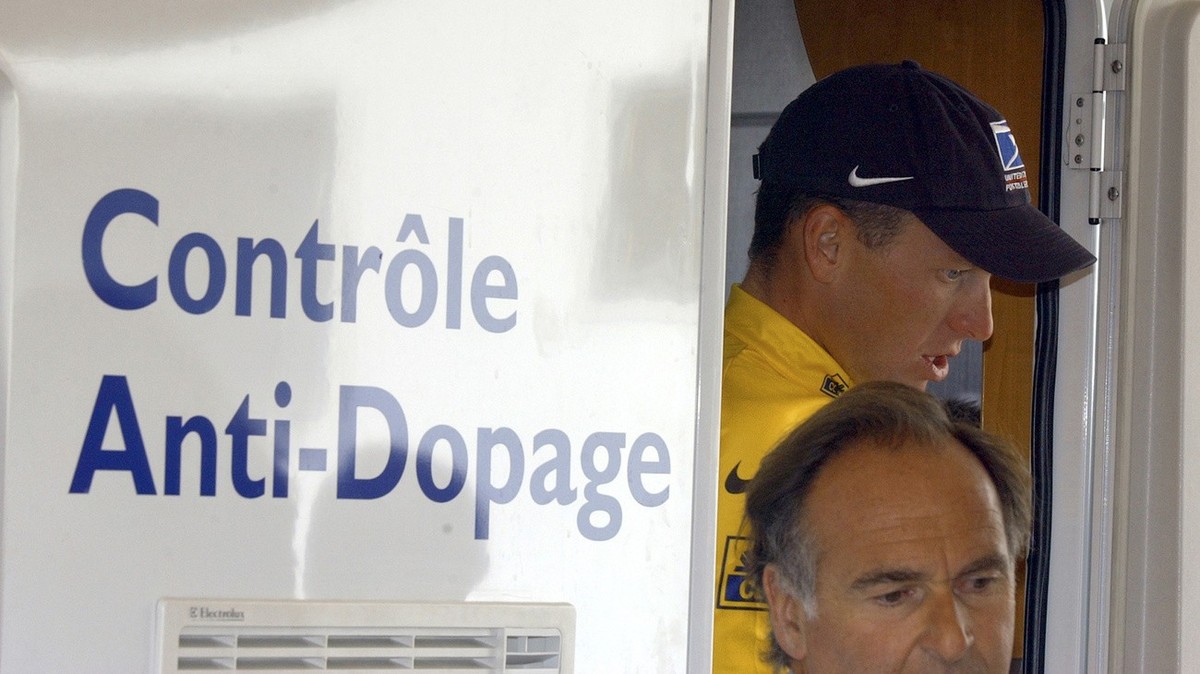 FILE - In this July 24, 2002, file photo, cyclist Lance Armstrong walks out of the Tour de France's anti-doping control bus after the 16th stage of the Tour de France cycling race between Les Deu ...