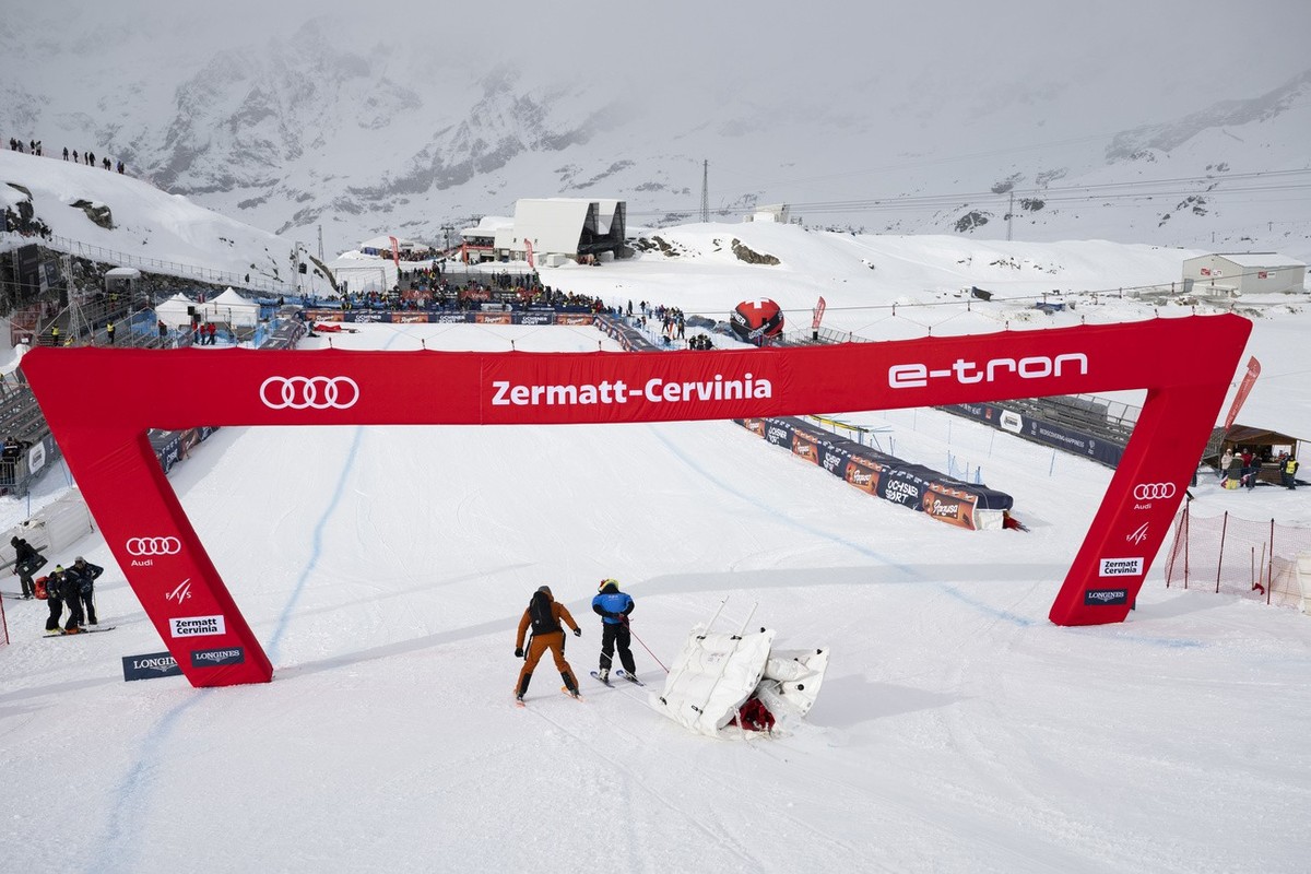 Workers remove an air fence after the women's downhill race was cancelled due to strong winds, on the new ski course "Gran Becca" at the Alpine Skiing FIS Ski World Cup Zermatt-Cervinia ...