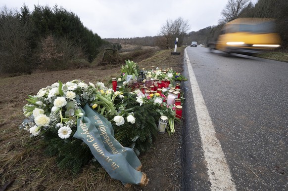 Flowers and candles stand in Ulmet, near Kusel, Germany, Friday, Feb. 4, 2022 at the scene where two police officers were shot during a traffic stop . German investigators have found nearly 400 cases  ...