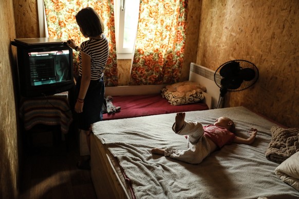 epa10998651 Sixteen years old Julia (L) watches TV inside her family&#039;s temporary module house at Kukhari village, Kyiv Region, Ukraine, 05 July 2023 EPA/OLEG PETRASYUK ATTENTION: This Image is pa ...