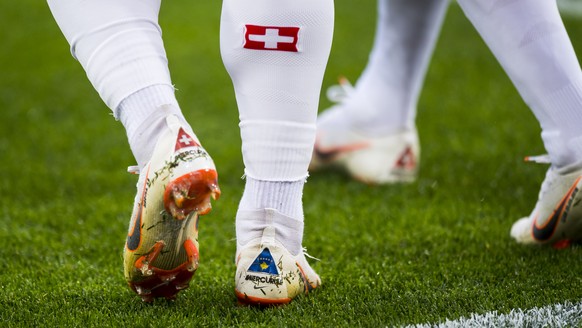 The legs of Switzerland&#039;s midfielder Xherdan Shaqiri, with the flags of Switzerland and Kosovo embroidered on the shoes during the FIFA World Cup 2018 group E preliminary round soccer match betwe ...