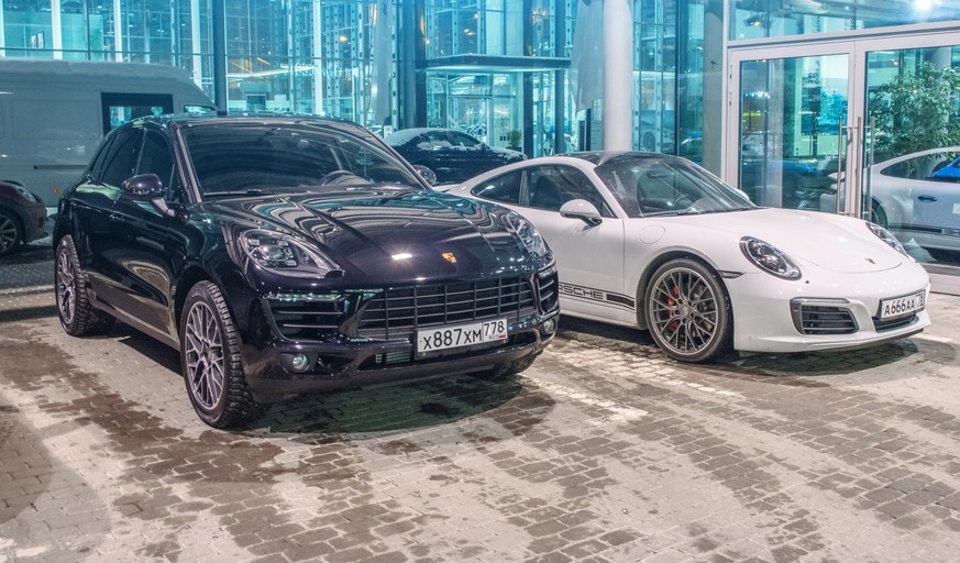 Porsche black Macan S and Porsche white 911 Carrera 4s. Russia, Saint-Petersburg. 02 March 2018