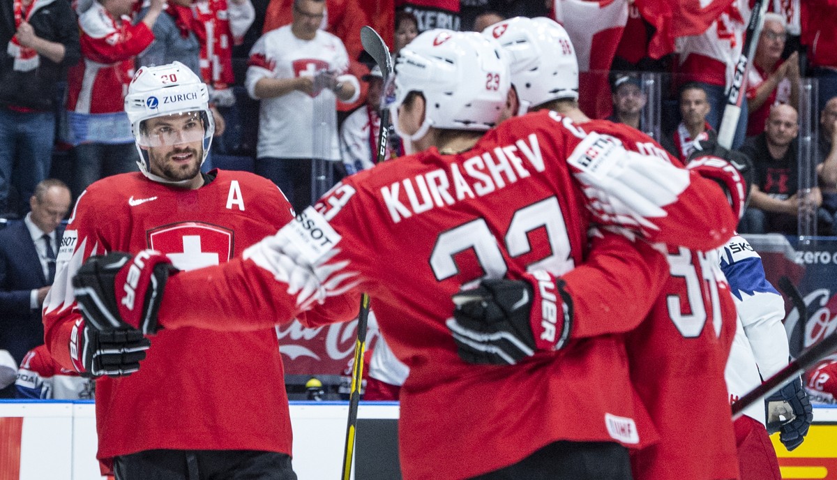Switzerland's Roman Josi , Switzerland's Philipp Kurashev and Switzerland's Lukas Frick, from left, celebrater after scoring 1:0 during the game between Czech Republic and Switzerland,  ...
