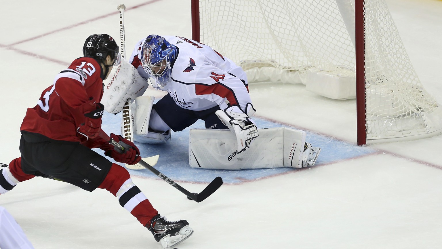 New Jersey Devils center Nico Hischier (13) of Switzerland, moves in for a score goal against Washington Capitals goalie Vitek Vanecek (41), of Czech Republic, during the third period of a preseason N ...