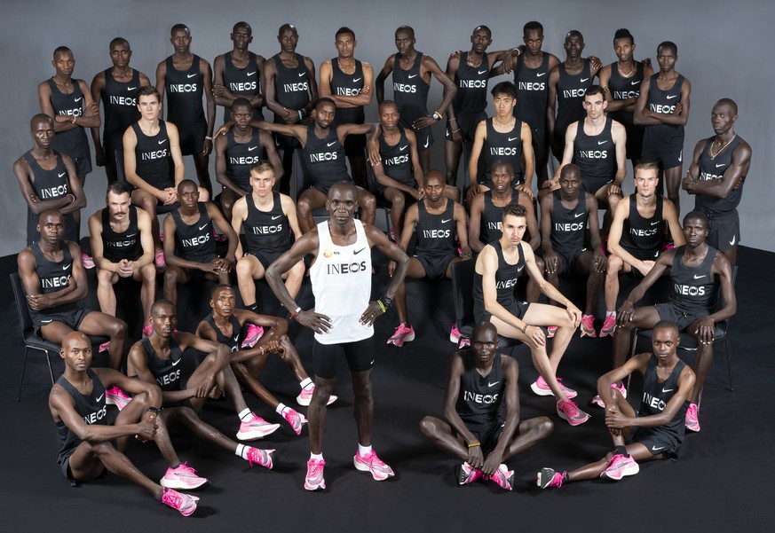 In this photo made available by The INEOS 1:59 Challenge on Thursday Oct. 9, 2019, Eliud Kipchoge of Kenya, center in white, stands with his pacemakers as he prepares to run a sub two-hour marathon se ...