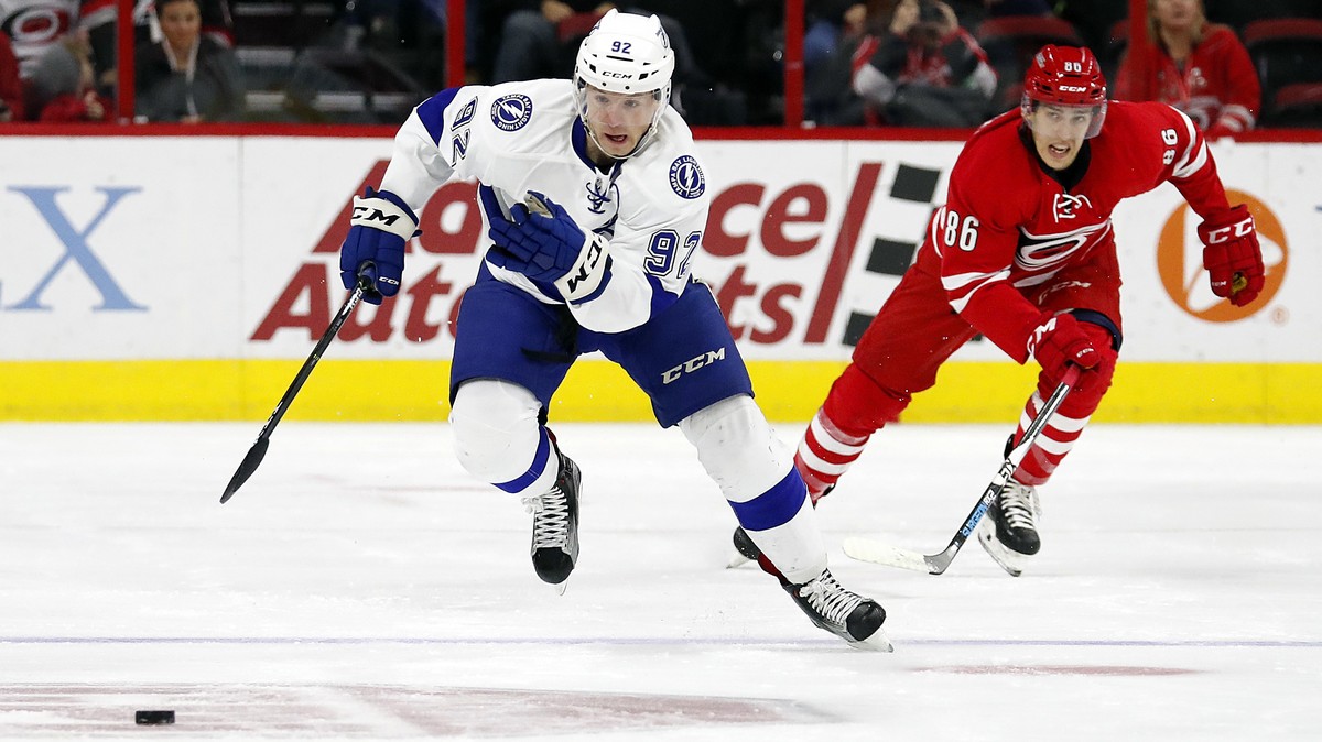 Tampa Bay Lightning's Joel Vermin (92) takes the puck down the ice after taking it away from Carolina Hurricanes' Teuvo Teravainen (86) during the first period of an NHL hockey game, Sunday, ...