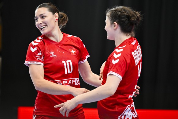 Daphne Gautschi of Switzerland, left, reacts after scoring with Era Baumann of Switzerland, during the Women&#039;s world championships qualifying handball match between Switzerland and Slovakia at th ...