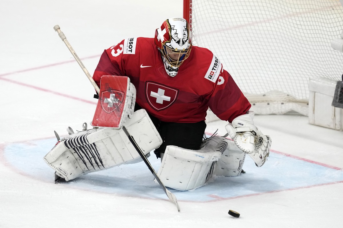 Switzerland's goalkeeper Leonardo Genoni stops a shot during the gold medal match between Czech Republic and Switzerland at the Ice Hockey World Championships in Prague, Czech Republic, Sunday, M ...