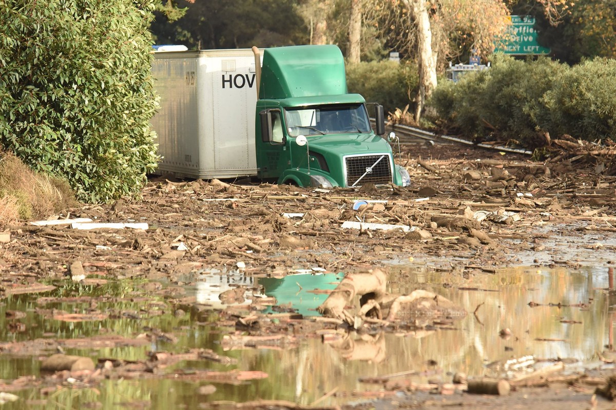 epa06427923 A handout photo made available by Santa Barbara County Fire Department shows a semi-tractor trailer sitting stuck in mud on US Highway 101 northbound just south of the San Ysidro Road offr ...
