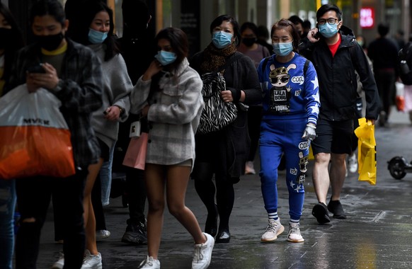 epa09518056 Shoppers wearing face masks walk in Pitt St Mall, following 108 days of lockdown in Sydney, New South Wales (NSW), Australia, 11 October 2021. Having surpassed the 70 percent double-dose v ...