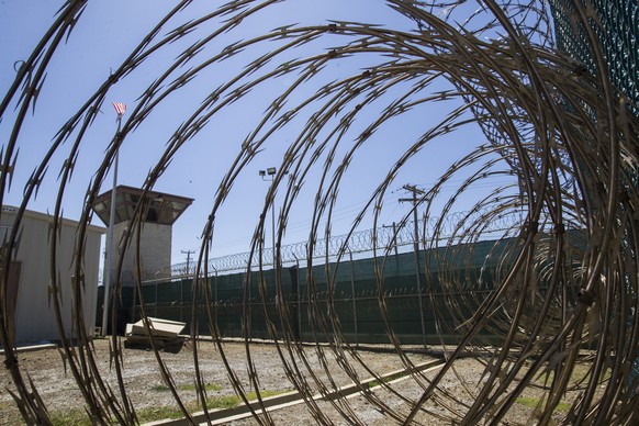 FILE - In this April 17, 2019, photo, reviewed by U.S. military officials, the control tower is seen through the razor wire inside the Camp VI detention facility in Guantanamo Bay Naval Base, Cuba. (A ...