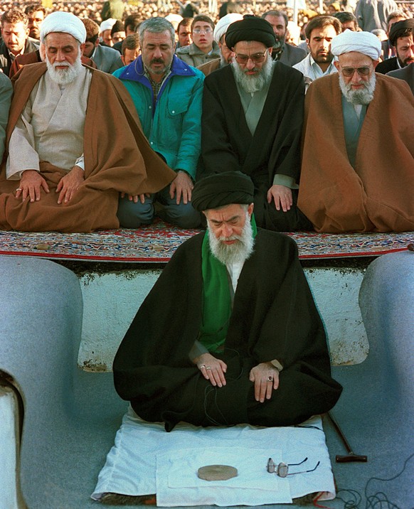 Iran's supreme leader Ayatollah Seyed Ali Khamenei, bottom center, Speaker of Majlis Ali Akbar Nategh-Nuri, left, Head of the Judiciary Ayatollh Mahmoud Hashemi Shahroudi, center, and Secretary G ...