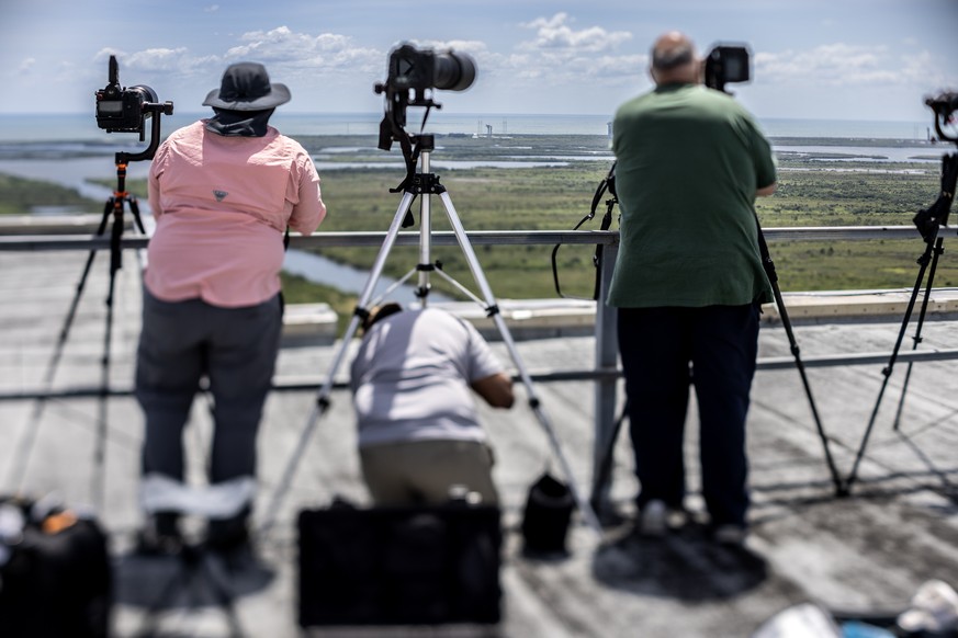 epa11384060 Members of the media remove their gear as the NASA Boeing Crew Flight Test mission Starliner spacecraft&#039;s launch was scrubbed minutes before the liftoff, in Cape Canaveral Space Force ...