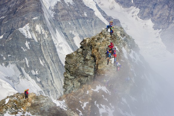 Delegations of the four nations, Switzerland, Italy, France and Great Britain climb the Matterhorn mountain, 4,478 meters over sea level, from different ridges in Zermatt, Switzerland, Friday, July 17 ...