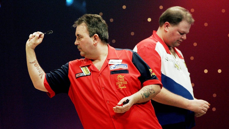 Phil Taylor (L), PDC world champion in action during his match against Dutch BDF world champion Raymond van Barneveld (R) during the Master of Darts tournament in Hengelo, Netherlands on Thursday 10 F ...