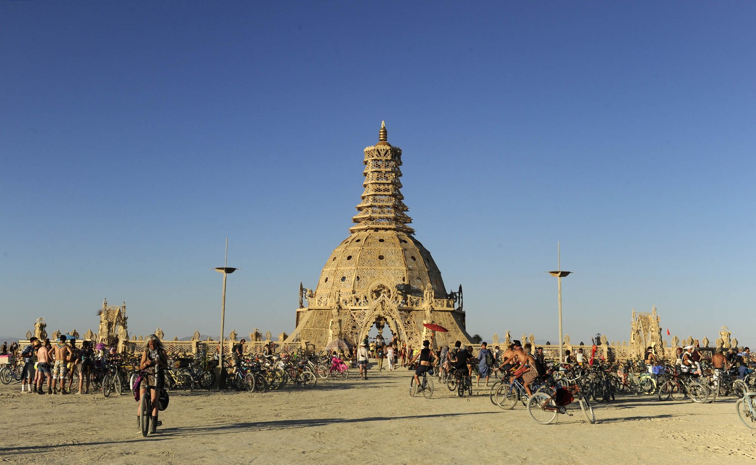 In this Aug. 23, 2014 photo, Burning Man participants gather at the Temple of Grace at the annual Burning Man event on the Black Rock Desert of Gerlach, Nev. (AP Photo/The Reno Gazette-Journal, Andy B ...