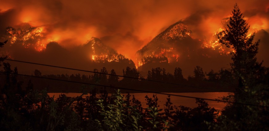 FILE - This Sept. 4, 2017, file photo provided by KATU-TV shows a wildfire as seen from near Stevenson, Wash., across the Columbia River, burning in the Columbia River Gorge above Cascade Locks, Ore.  ...