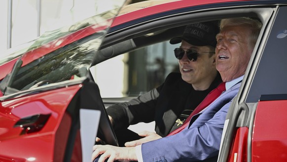 FILE - President Donald Trump and Tesla CEO Elon Musk speak to reporters as they sit in a red Model S Tesla vehicle on the South Lawn of the White House, March 11, 2025, in Washington. (Pool via AP, F ...