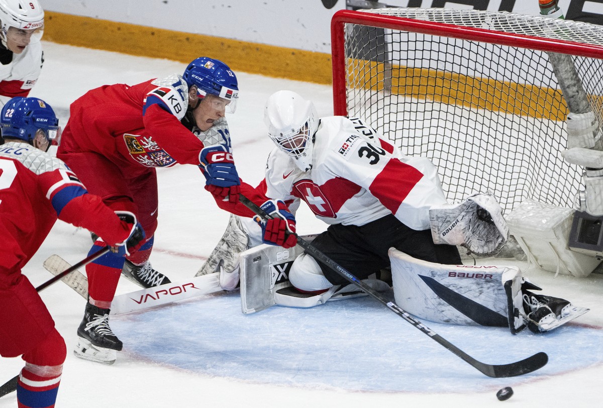 Czechia forward Eduard Sale (12) loses control of the puck in front of Switzerland goaltender Elijah Neuenschwander (30) during third-period IIHF World Junior Hockey Championship preliminary round gam ...