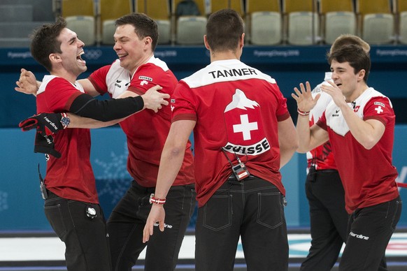 Peter de Cruz, Claudio Paetz, Valentin Tanner and Benoit Schwarz of Switzerland, from left, celebrate after winning the Curling Bronze Medal game of the men between Switzerland and Canada at the XXIII ...