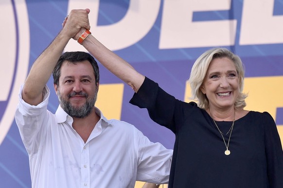 epa10866200 Italy&#039;s Lega party leader Matteo Salvini (L) with president of France&#039;s Rassemblement National Marine Le Pen (R) join hands during the traditional Lega (League) party rally in Po ...