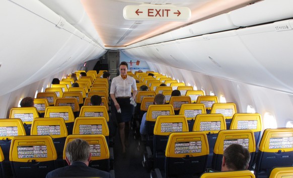 FILE- In this Tuesday, April 12, 2016 file photo, an attendant collects rubbish on a Ryanair media flight from Dublin to Gatwick Airport, London. Ryanair issued a statement Monday, Aug. 14, 2017, call ...