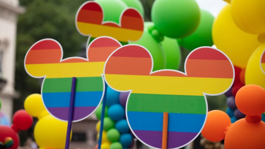 LONDON, UK - July 6th 2019: Disnry Micky Mouse icon with gay rainbow flag design at the annual gay pride march in central London
