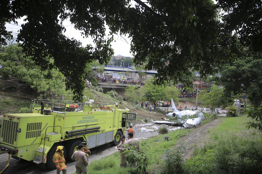 epa06756535 Authorities work in the area where an executive jet plane with US registration crashed in Tegucigalpa, Honduras, 22 May 2018. The plane, with at least six people on board, crashed at the e ...