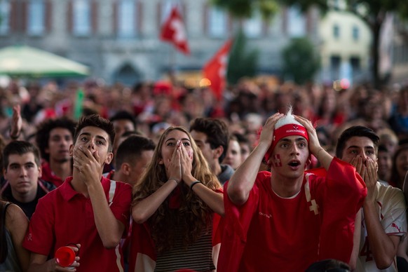 epa05378056 Swiss fans react during the UEFA EURO 2016 group A preliminary round soccer match between France and Switzerland, at a public viewing in Lugano, Switzerland, 19 June 2016. EPA/GABRIELE PUT ...