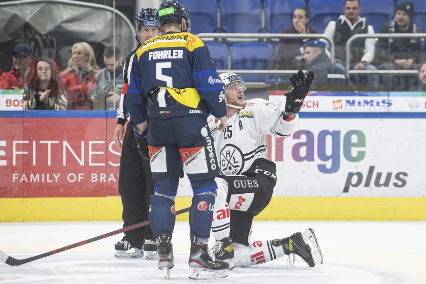 From left, Ambri&#039;s player Tobias Fohrler and Lugano&#039;s player Mirco Mueller, during the preliminary round game of National League A (NLA) Swiss Championship 2022/23 between, HC Ambri Piotta a ...