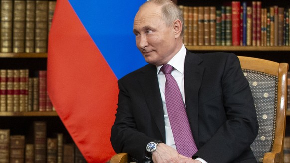 US President Joe Biden, left, and Russian President Vladimir Putin during their meeting at the US - Russia summit in the library of the Villa La Grange, in Geneva, Switzerland, Wednesday, June 16, 202 ...