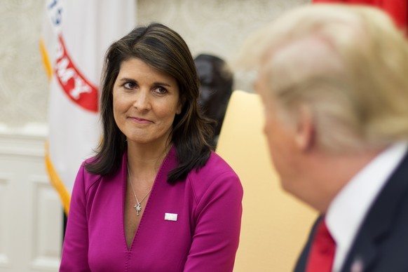 epa07081170 US Ambassador to the United Nations Nikki Haley (L) listens to US President Donald J. Trump (R) deliver remarks to members of the news media in the Oval Office of the White House in Washin ...