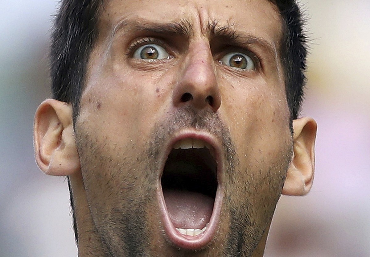FILE - Serbia's Novak Djokovic celebrates winning a point against Spain's Roberto Bautista Agut in a Men's singles semifinal match on day eleven of the Wimbledon Tennis Championships in ...