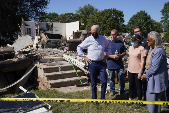 FILE - In this Sept. 7, 2021, file photo President Joe Biden tours a neighborhood impacted by Hurricane Ida in Manville, N.J. Rep. Bonnie Watson Coleman, D-N.J., looks on at right. Surveying damage fr ...