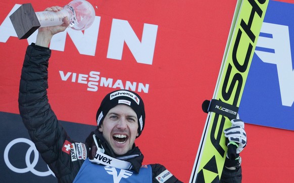 epa06435779 Simon Ammann of Switzerland celebrates on the podium after the Ski Jumping World Cup competition in Bad Mitterndorf, Austria, 13 January 2018. EPA/LISI NIESNER