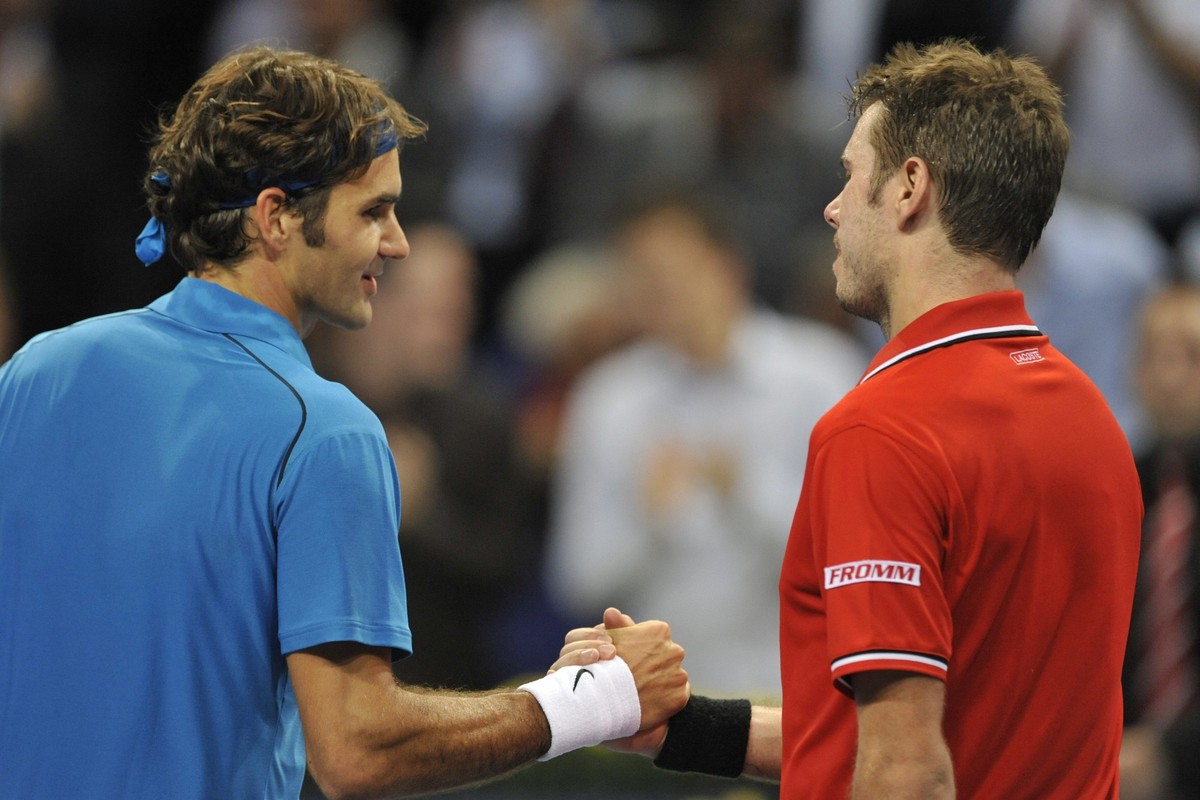 Switzerland's Roger Federer, left, shakes hands with Switzerland's Stanislas Wawrinka, right, after winning the semifinal match at the Swiss Indoors tennis tournament at the St. Jakobshalle  ...