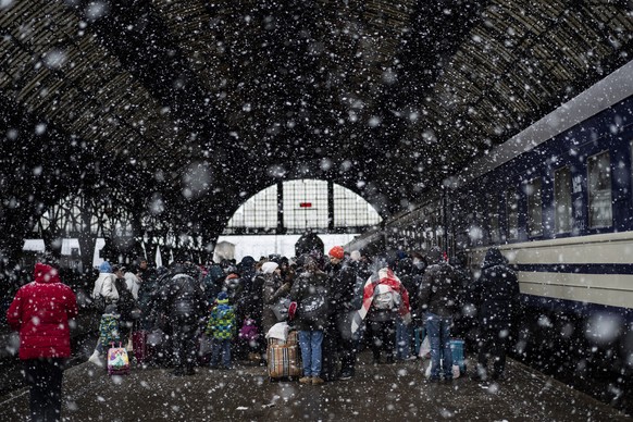Passengers waiting for a train to Poland inside Lviv railway station, Sunday, Feb. 27, 2022, in Lviv, west Ukraine. The U.N. has estimated the conflict could produce as many as 4 million refugees. (AP ...
