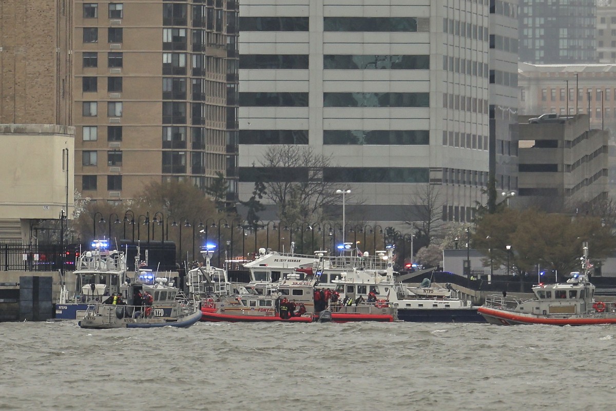 As seen from Pier 40 in New York, police and fire crews from New York and New Jersey respond to the scene Thursday, April 10, 2025, where a helicopter went down in the Hudson River between Manhattan a ...